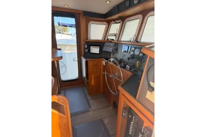 2001 Nordhavn 40 - Wayward Snug - Pilothouse helm station with wheel, instrument panel, and windows