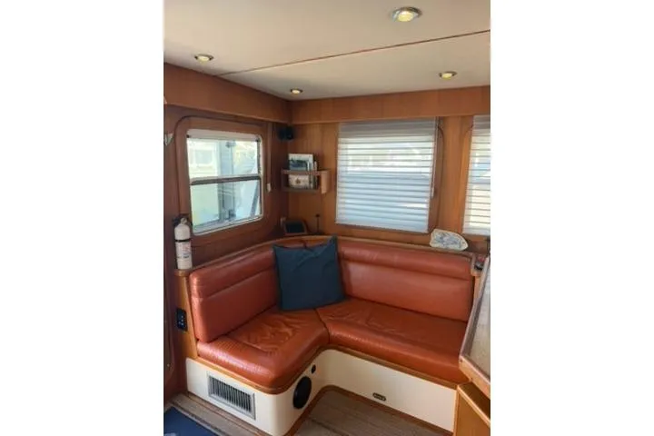 2001 Nordhavn 40 - Wayward Snug - Salon starboard settee with teak paneling and AC unit