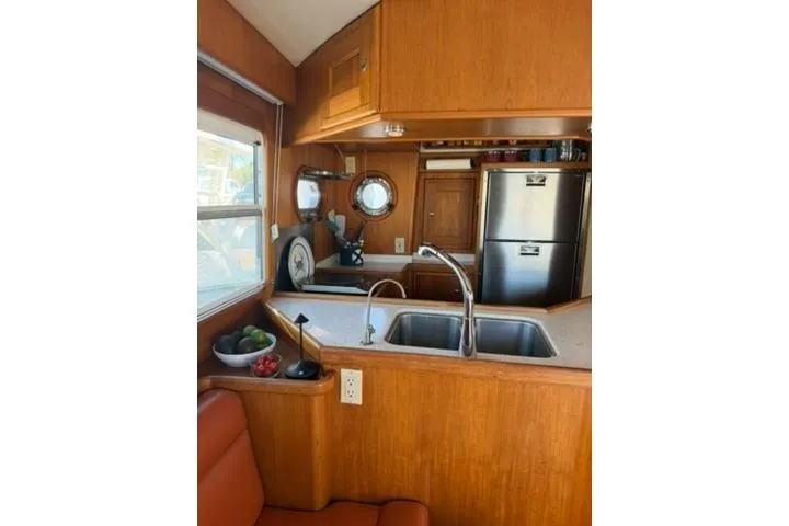2001 Nordhavn 40 - Wayward Snug - Galley closeup with double sink, countertop, porthole, and stainless refrigerator