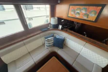 2016 Nordhavn 60 - CHOICES - Salon forward settee corner with fish artwork and quilted cushions