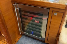 2016 Nordhavn 60 - CHOICES - Wine cooler in salon teak cabinetry