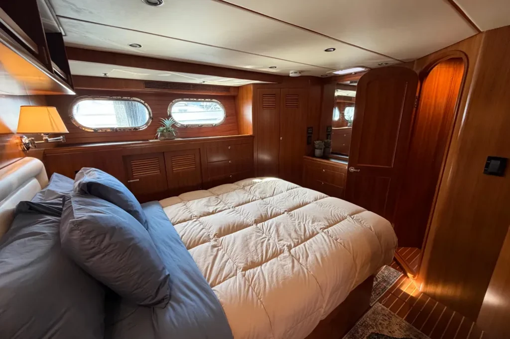 2016 Nordhavn 52 - Aleoli - Primary stateroom looking aft with island queen berth, portlights, and en suite head door