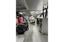 2016 Nordhavn 52 - Aleoli - Engine room center aisle looking forward with Yanmar wing engine port side, John Deere main starboard, and Northern Lights generator forward