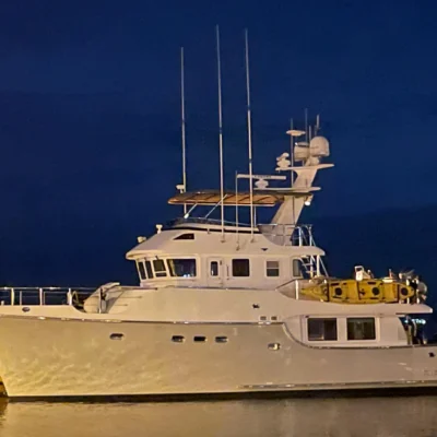 2006 Nordhavn 55 Trawler Honey Badger docked at night showing full profile with radar mast and navigation equipment