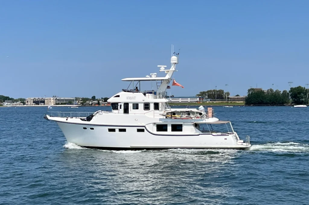 2011 Nordhavn 60 Trawler ONYXIA cruising on calm blue water under clear skies