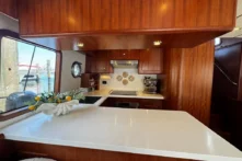 2025 Nordhavn 475 Listo galley detail with induction cooktop, under-counter oven, and white Corian countertops