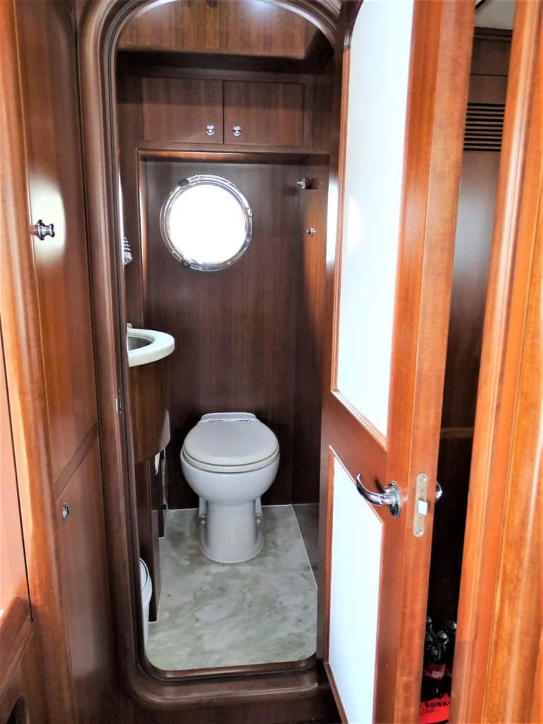 2011 Nordhavn 60 Trawler ONYXIA head with wood interior and porthole window