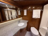 N6416 - AEGEAN MIST - master head bathroom with grey granite countertop, undermount sink, chrome faucet, framed mirror, towel bars, and glass shower visible in reflection