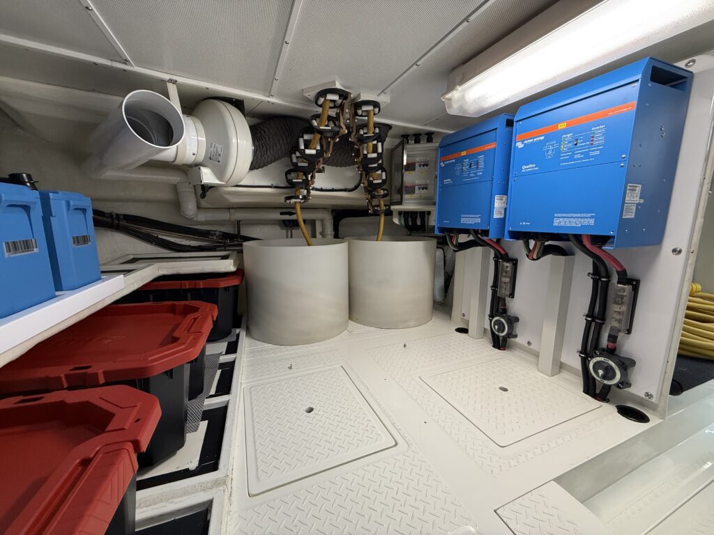 N6416 - AEGEAN MIST - below-decks compartment with dual Victron Energy Quattro inverter/chargers, large holding tanks, PVC piping, and storage bins
