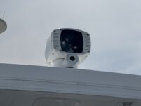 N6416 - AEGEAN MIST - close-up of FLIR thermal and optical camera mounted on mast above the pilothouse against a grey overcast sky