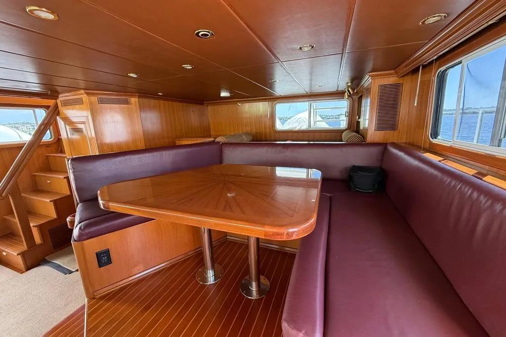 2006 Nordhavn 64 - KARIWA 23 - Luxurious 2006 Nordhavn 64 yacht interior with wooden dining area and plush seating.