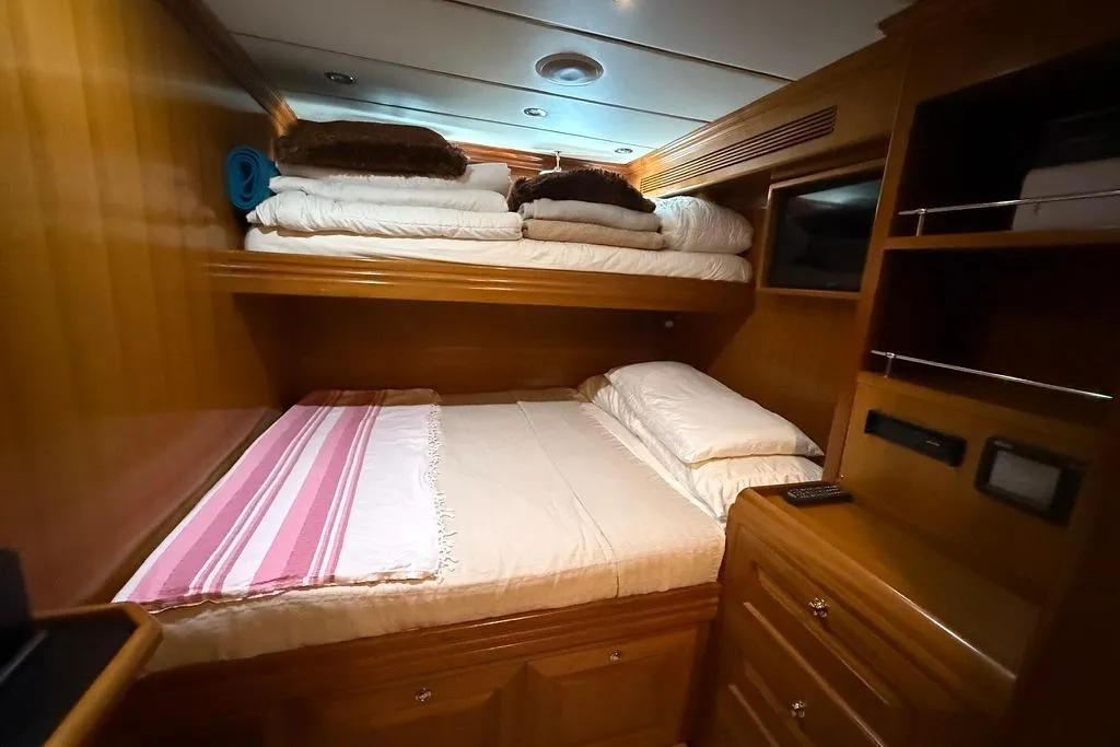 2006 Nordhavn 64 - KARIWA 19 - Cozy cabin interior of 2006 Nordhavn 64 yacht with wooden furnishings and bunk beds.
