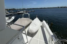 2006 Nordhavn 64 - KARIWA 27 - Deck view of 2006 Nordhavn 64 yacht with covered equipment, overlooking marina.