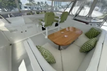2006 Nordhavn 64 - KARIWA 26 - Luxurious 2006 Nordhavn 64 yacht interior with green seating, wooden table, and scenic windows.