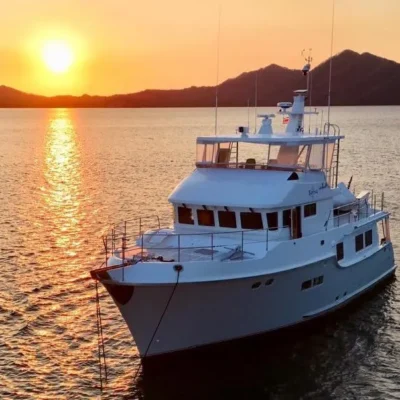 2006 Nordhavn 64 - KARIWA 1 - 2006 Nordhavn 64 yacht at sunset on tranquil waters.