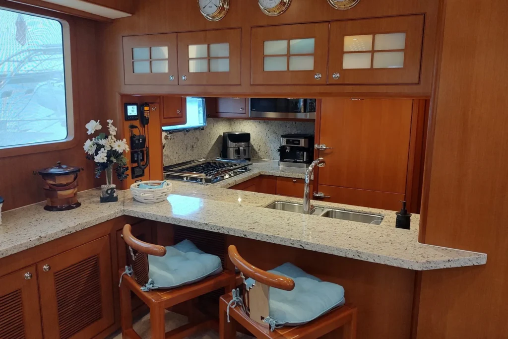 2017 Nordhavn 60 - REDEEMED 13 - Luxurious 2017 Nordhavn 60 yacht kitchen with granite countertops and wooden cabinetry.