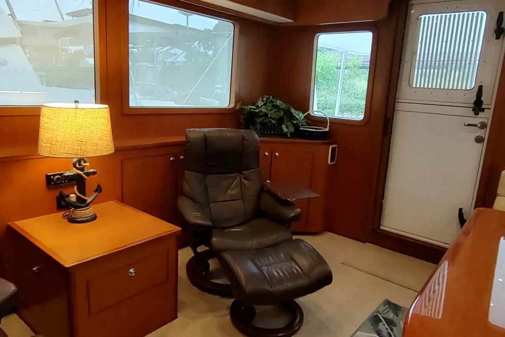 2017 Nordhavn 60 - REDEEMED 16 - Luxurious interior of 2017 Nordhavn 60 yacht with leather chair and wooden furnishings.