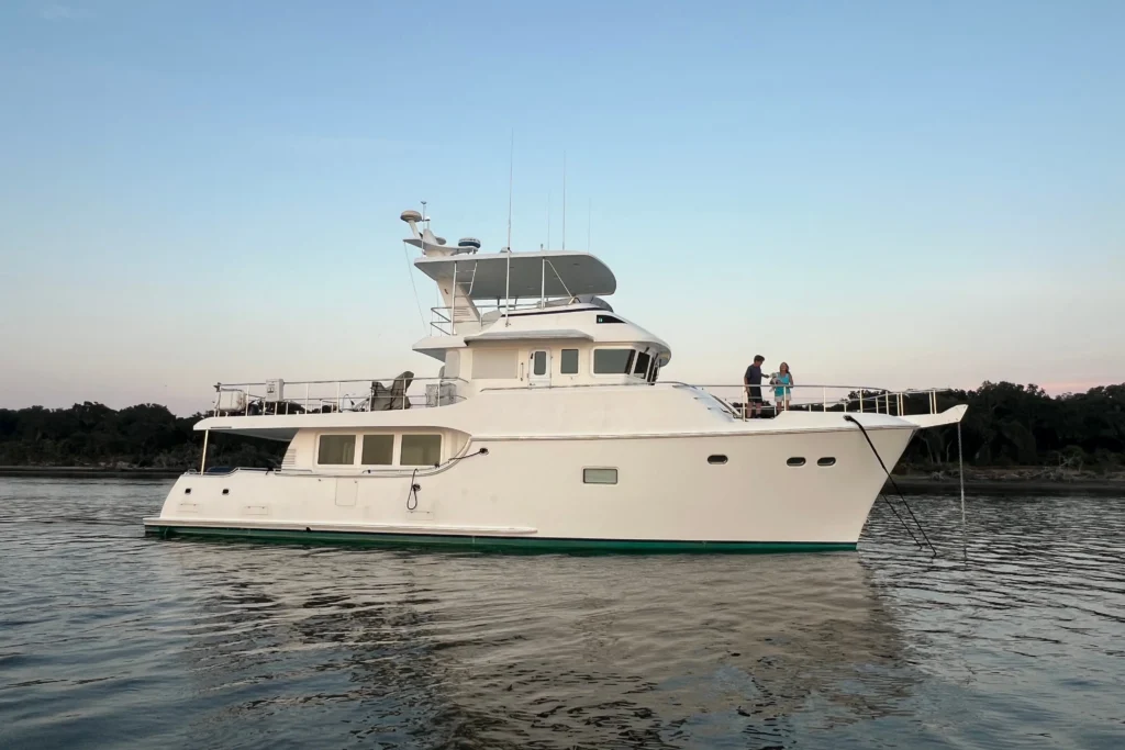 2017 Nordhavn 60 - REDEEMED 4 - 2017 Nordhavn 60 yacht anchored on calm water at sunset.