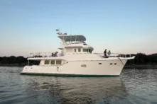 2017 Nordhavn 60 - REDEEMED 4 - 2017 Nordhavn 60 yacht anchored on calm water at sunset.