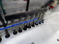 2017 Nordhavn 60 - REDEEMED 32 - An engine lube oil manifold with multiple valves and hoses in a Nordhavn 60 boat.