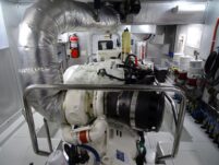 2017 Nordhavn 60 - REDEEMED 33 - The engine room of a 2017 Nordhavn 60 features a large engine with silver insulation.