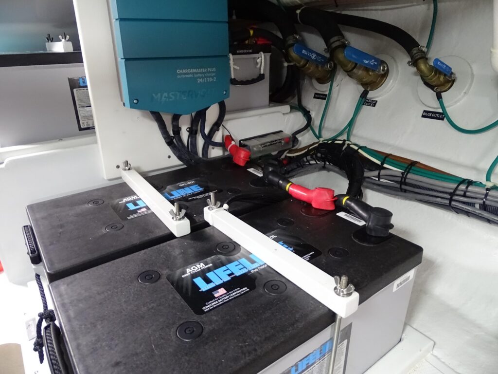 2017 Nordhavn 60 - REDEEMED 42 - Batteries and wiring in a 2017 Nordhavn 60, with a charger mounted on the wall.