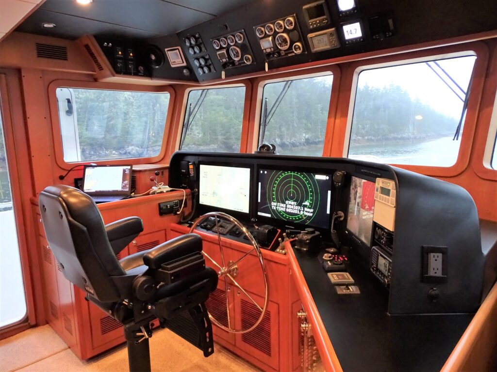2017 Nordhavn 60 - REDEEMED 23 - The image shows the helm of a 2017 Nordhavn 60 with modern navigation equipment.