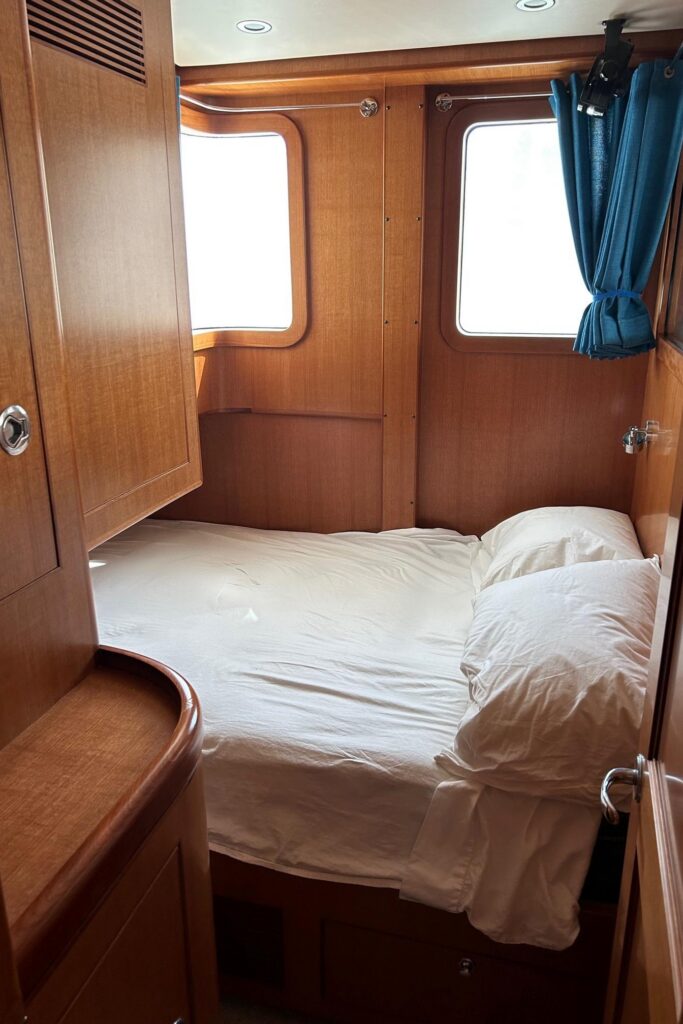 2017 Nordhavn 60 - REDEEMED 30 - Cabin of the 2017 Nordhavn 60 with a cozy bed and wooden walls.