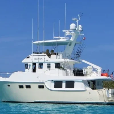 2008 Nordhavn 55 - ADVENTURE 1 - 2008 Nordhavn 55 yacht on turquoise water under clear blue sky.